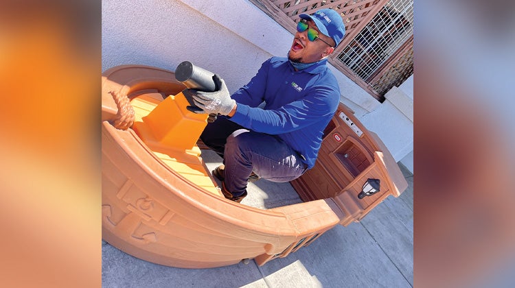 Weird Junk 2024 Toy Ship 1-800-GOT-JUNK? truck team member inside a mini toy ship