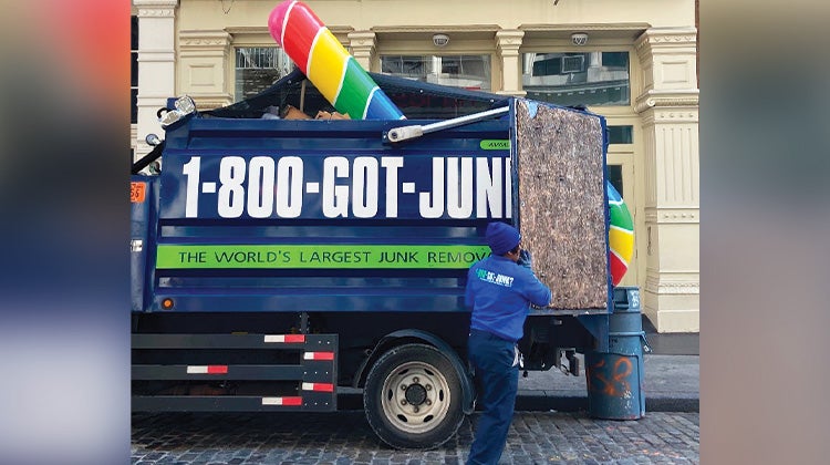 Weird Junk 2024 Giant Candy Cane Gian candy cane loaded into the back of a 1-800-GOT-JUNK? truck