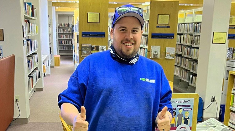1-800-GOT-JUNK? team member smiling in library 1-800-GOT-JUNK? team member smiling in library