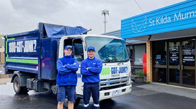 Two 1-800-GOT-JUNK? team members in front of truck Two 1-800-GOT-JUNK? team members in front of truck