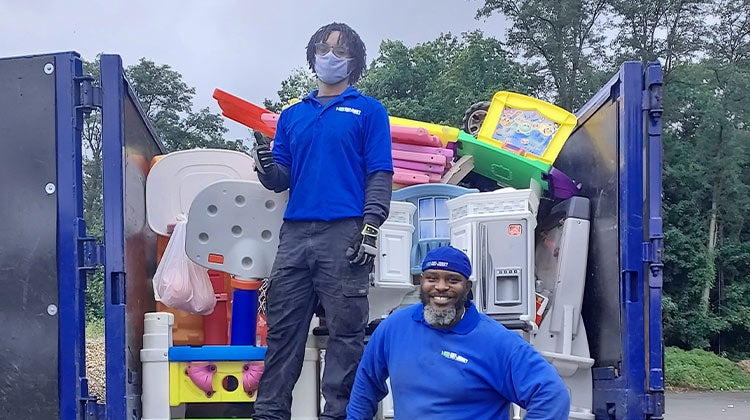 Two 1-800-GOT-JUNK? team members with truck full of toy donations Two 1-800-GOT-JUNK? team members with truck full of toy donations
