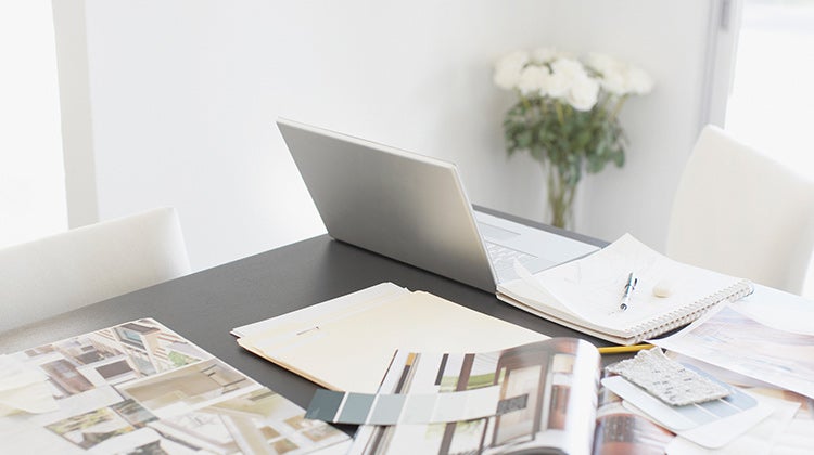 Laptop and design magazines spread out on a table Laptop and design magazines spread out on a table