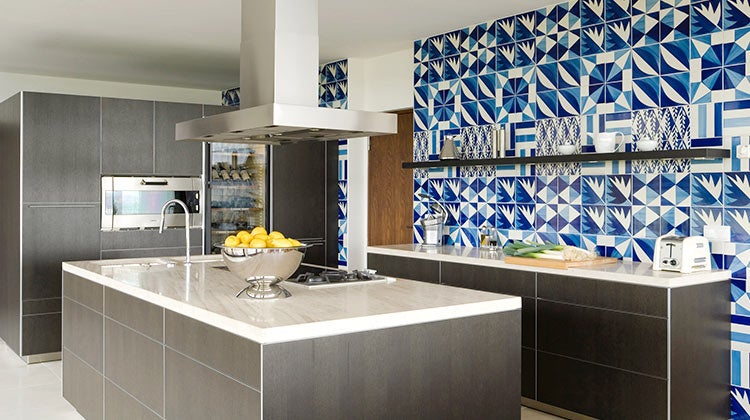 Clean kitchen with a blue patterned tile backsplash Clean kitchen with a blue patterned tile backsplash