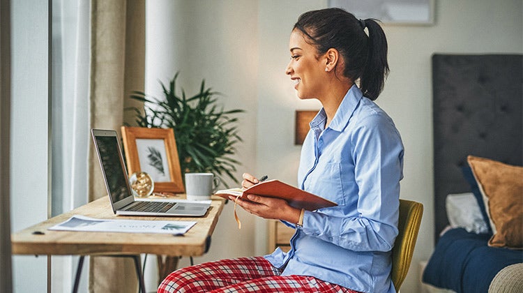 Woman working from home wearing pajama pants Woman working from home wearing pajama pants