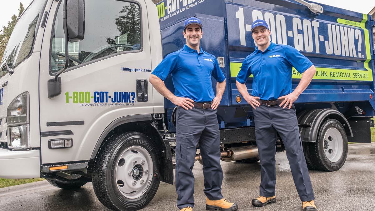 Happy TOMs standing by a 1-800-GOT-JUNK? truck Happy TOMs standing by a 1-800-GOT-JUNK? truck