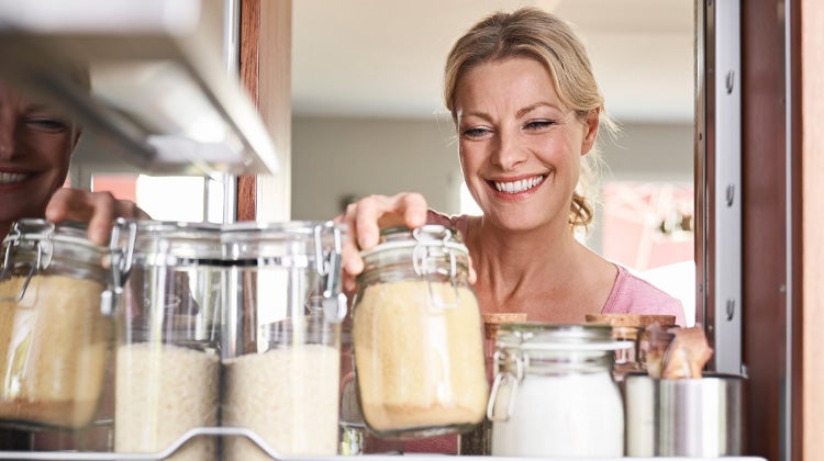 Woman reaching into a pantry for flour Woman reaching into a pantry for flour