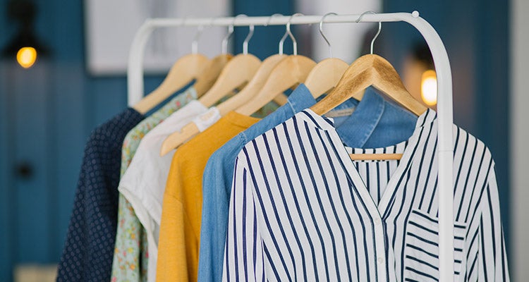 Shirts hung on a white clothing rack Shirts hung on a white clothing rack