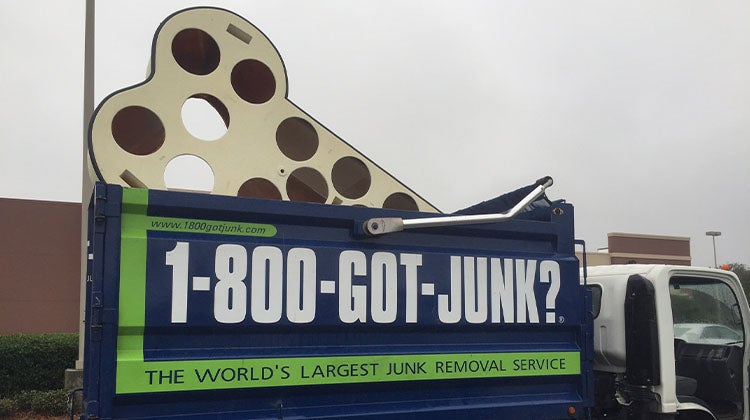 Large bone sculpture sticking out of a 1-800-GOT-JUNK? truck Large bone sculpture sticking out of a 1-800-GOT-JUNK? truck